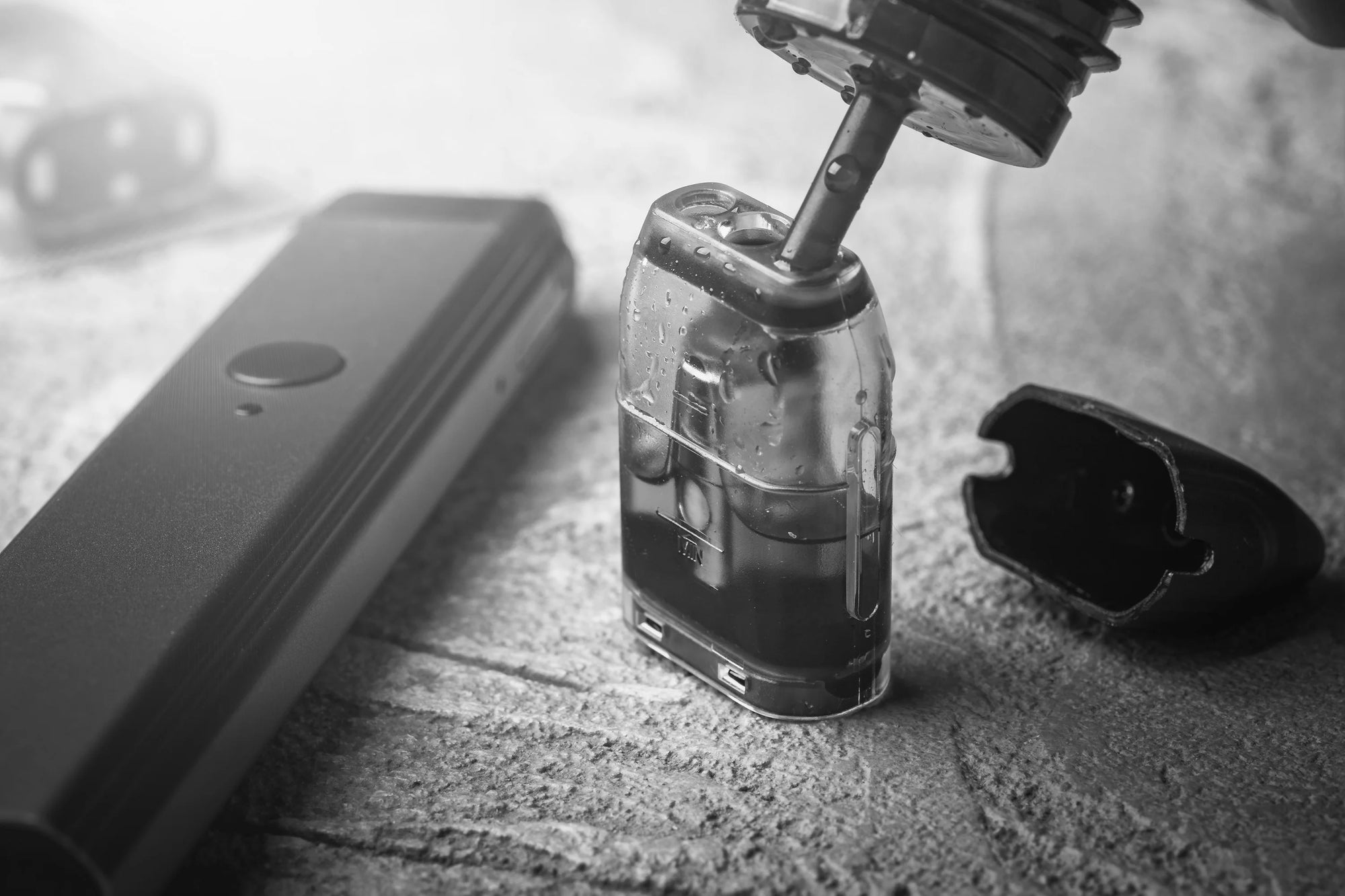 Close-up of a vape pod being filled with e-liquid