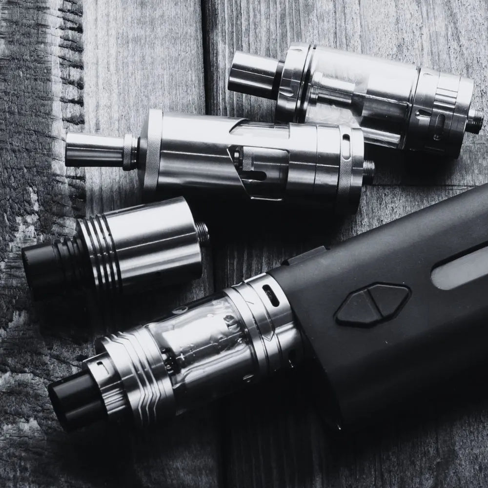 Image of refillable vape device and parts in black & white