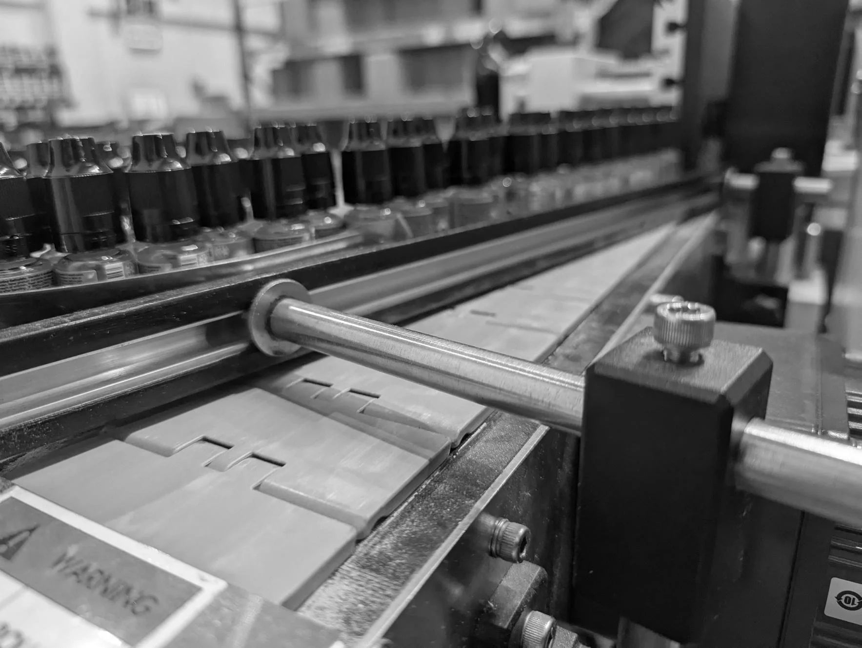 Black and white image of vape bottles being processed