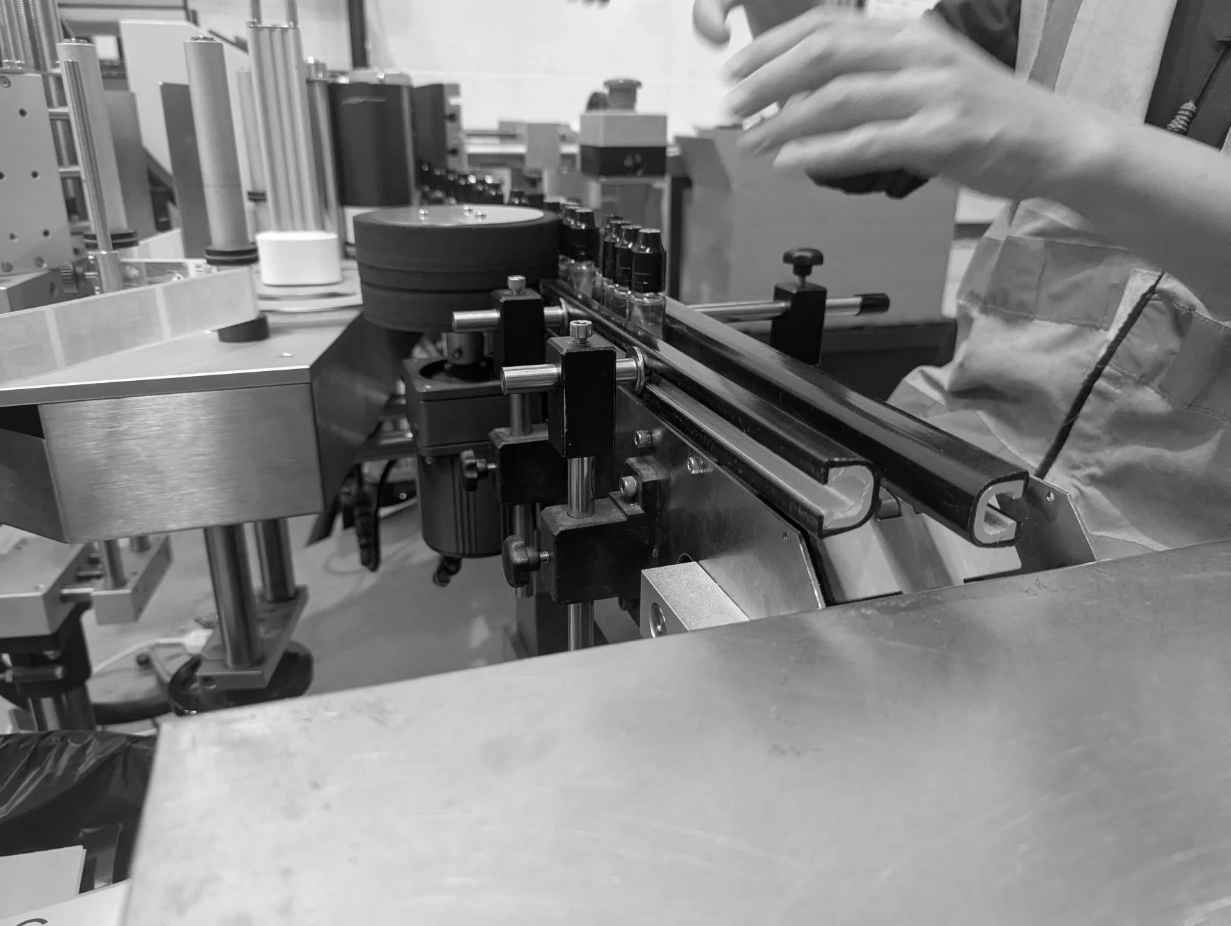 Vape juice bottles being manually handled and prepared