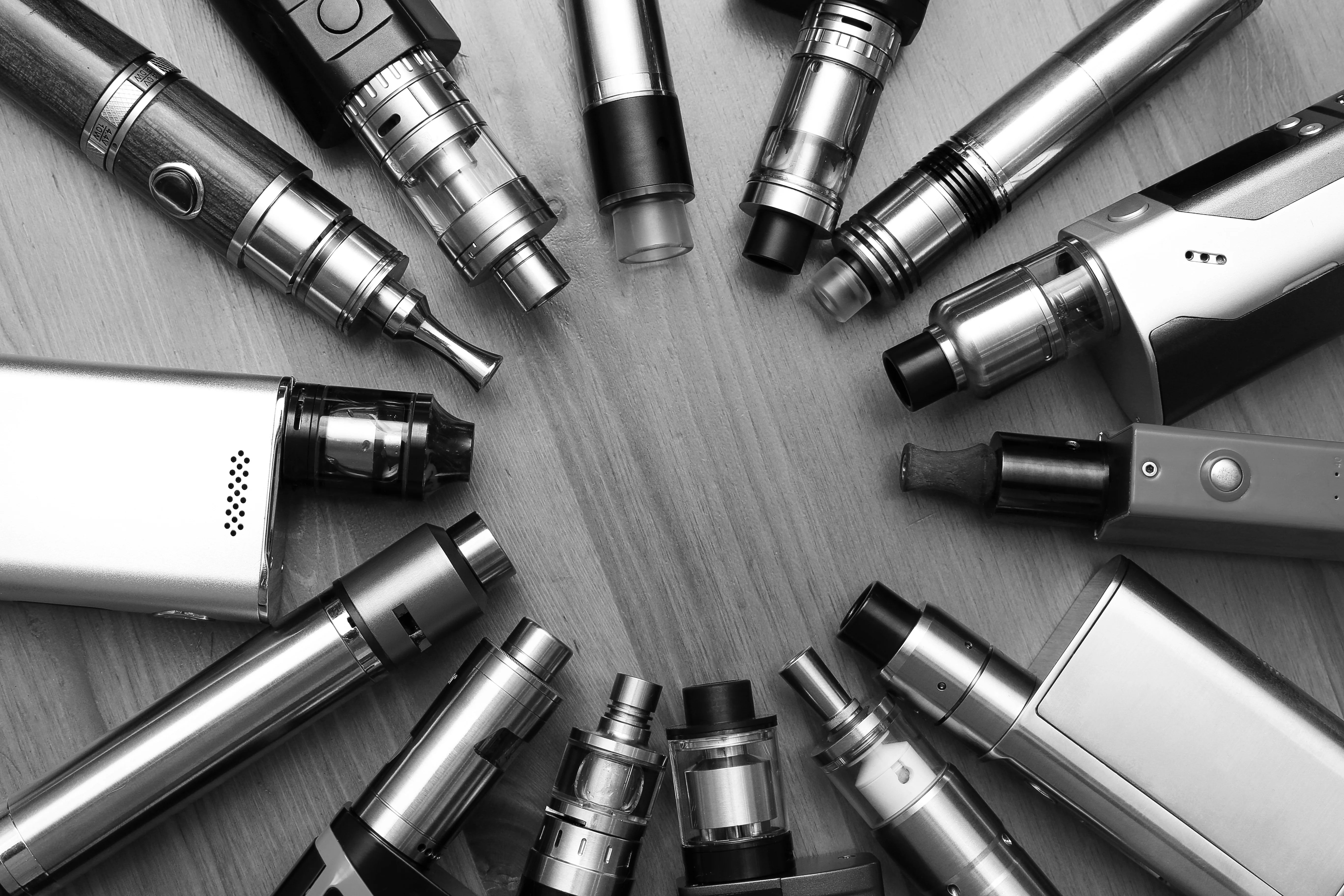 a black and white image featuring a range of vape kits
