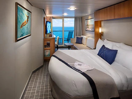 Cruise ship cabin with bed, desk, and ocean view