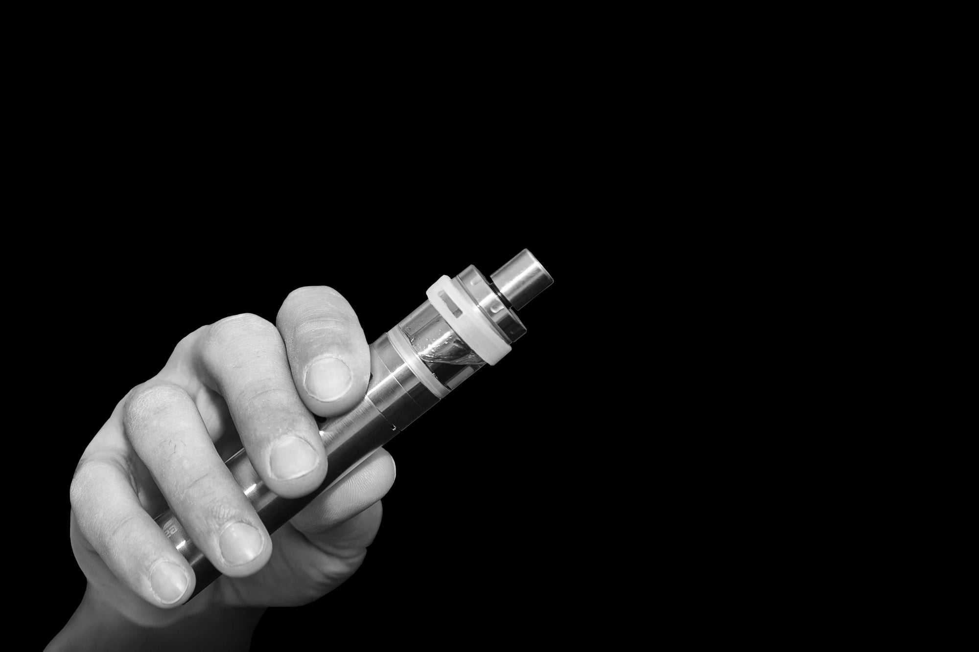 Vaping device in hand black and white