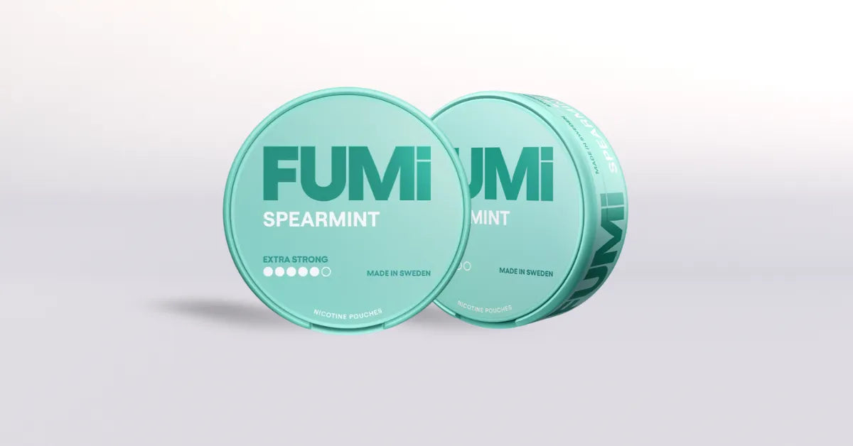 Two green nic pouch containers labeled 'FUMI Spearmint' on a light gray background