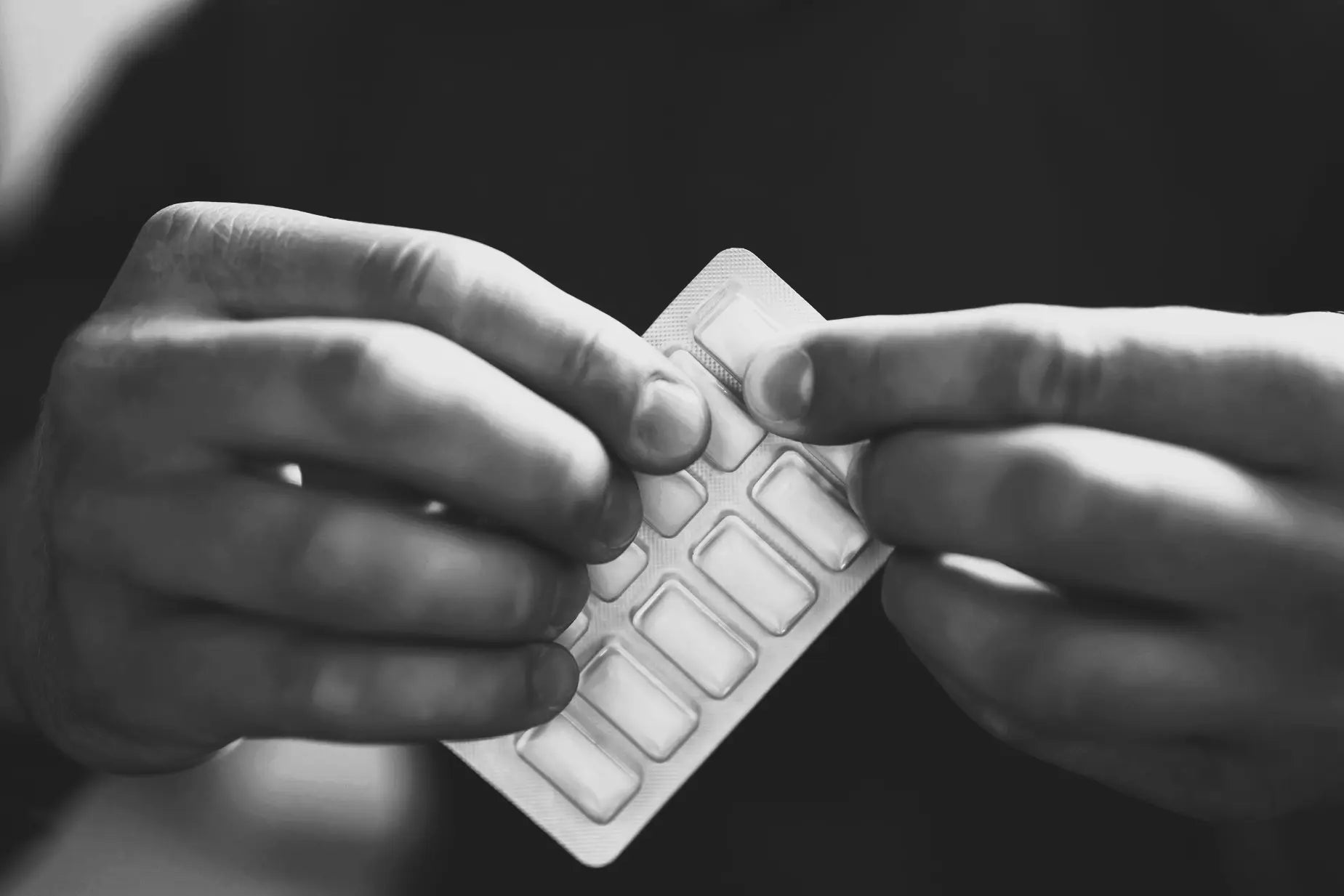hands holding nicotine gum